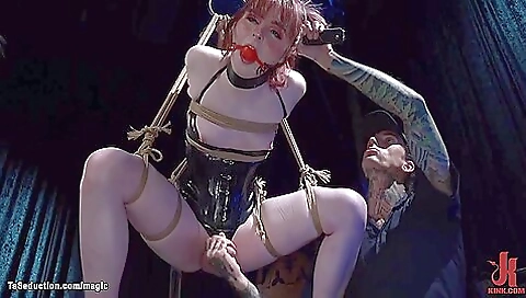 A redhead in bondage bondage is tied up and fucked